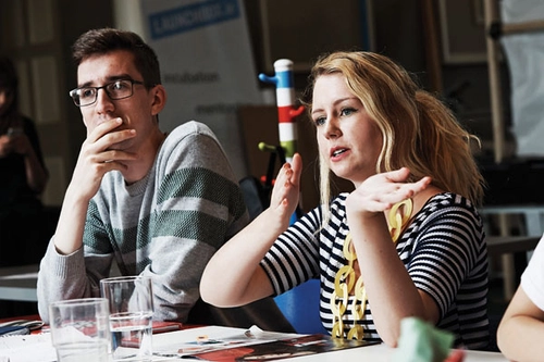 Two students interacting with a tutor at a seminar