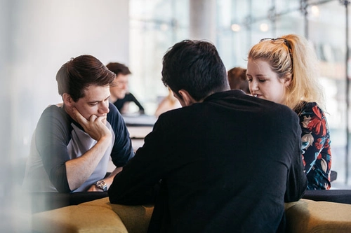 Three students deep in conversation