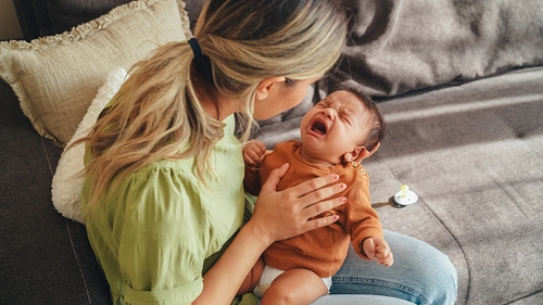 Mother holding newborn in ward
