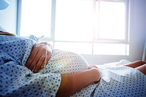Pregnant woman in hospital bed