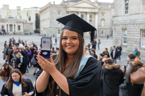Student smiling at graduation with medal
