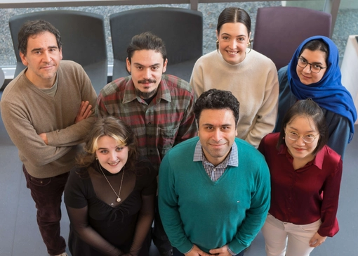 A group of people standing together facing up towards the camera