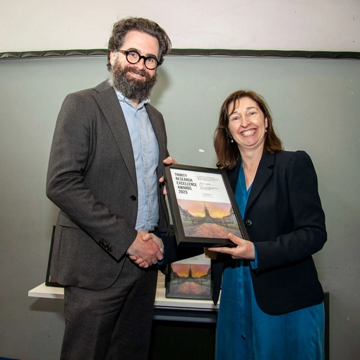 Andrew Gibson receiving an award from Sinéad Ryan