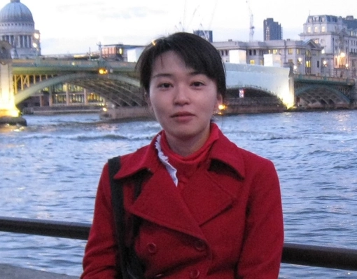 Sae Kitamura, Visiting researcher standing by a river and bridge