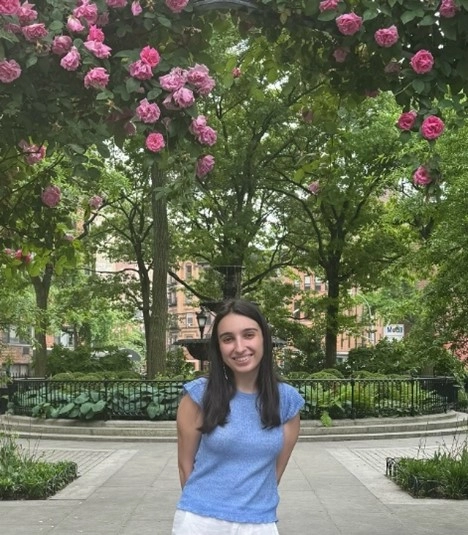 Sinziana Stanciu, Researcher standing in front a garden with trees