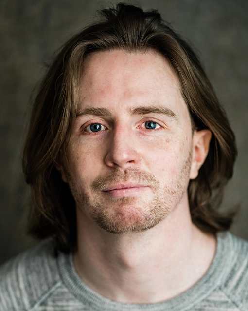 Student with shoulder length brown hair, looking at the camera.
