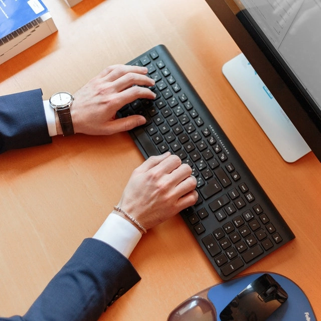 A person typing on a keyboard