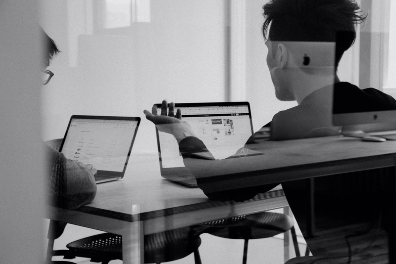 two students studying with computers