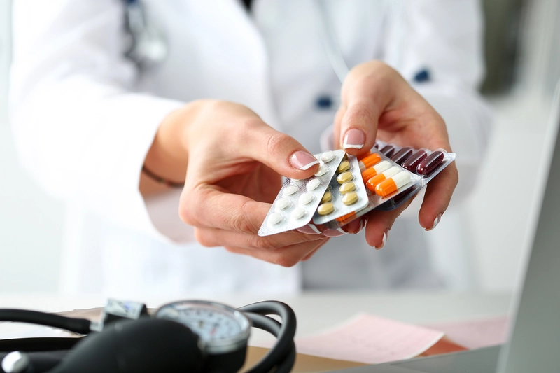 hands holding medicine tablets