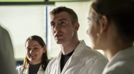 An image of Dr Joseph Mooney in a lab coat