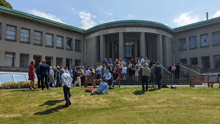 Image of IT Services staff on a sunny day gathering outside the steps of the Moyne Institute on campus
