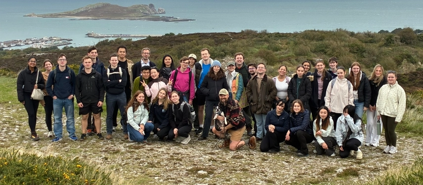Group gathered on a hillside overlooking the sea and Ireland's Eye during the Annual Howth walk.