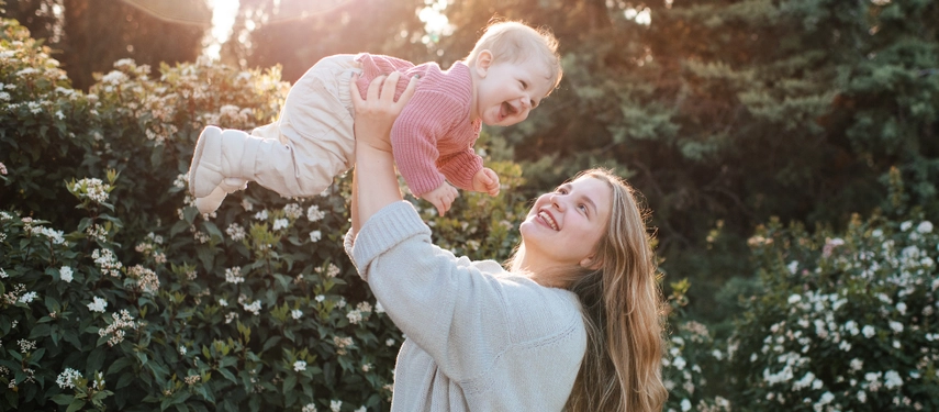 Mother holding child in the air