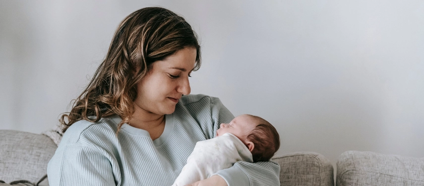 Woman holds newborn baby