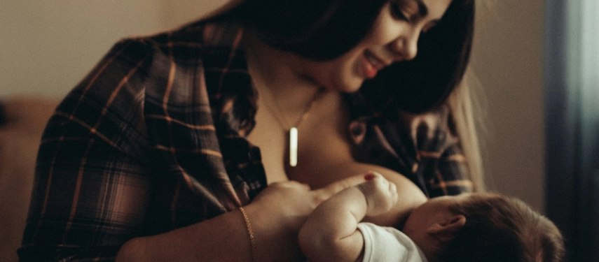 Woman breastfeeds her baby