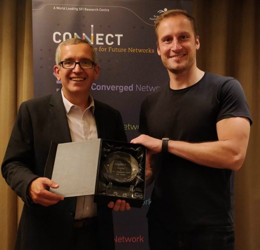 Professor Luiz DaSilva (left) presents the Education and Public Engagement Award to Dr Jacek Kibilda.