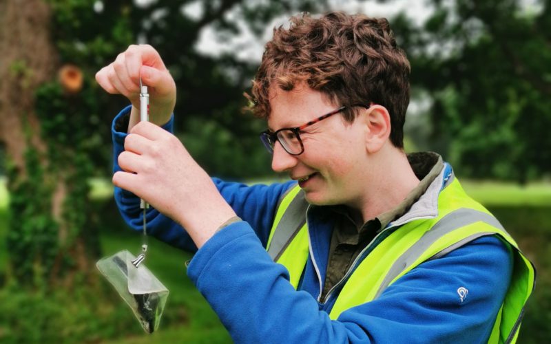 Fionn Ó Marcaigh, from Trinity's School of Natural Sciences, weighs a great tit (Parus major) under license. Photo: Dr Aoibheann Gaughran.