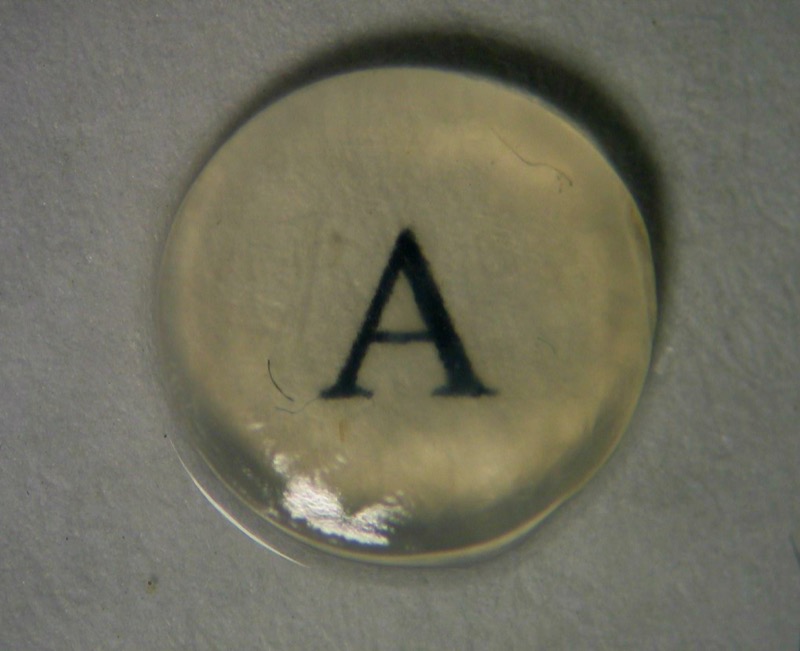 A bio-engineered cornea sitting atop a letter A, to indicate the transparency of the material.