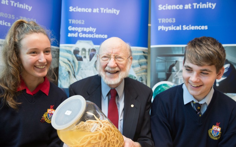 Prof William Campbell with students, Leah Paul and Eimhin Bolger from Wesley College, on the occasion of the launch, inspecting some parasites.