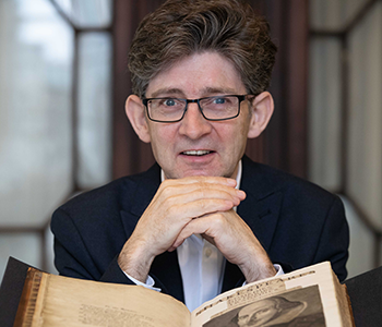 Andrew Murphy with an open book in front of him