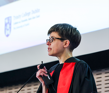 Professor Catherine Welch standing in front of a lecture screen