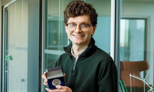 Daniel Gilligan receiving his Research award