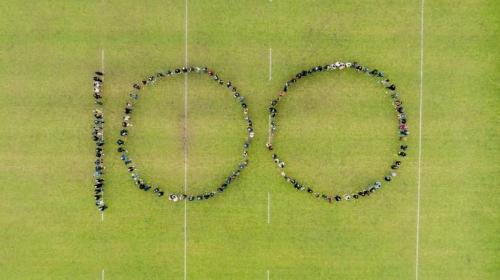 Image of Trinity Business School Students and staff making the shape of the number 100.