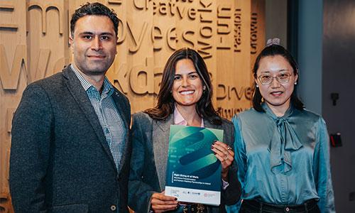 Image of Taha Yasseri, Dr Marina Schenkel and Dr Hao Cui with a copy of their research study.
