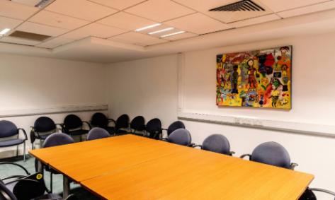 Room  b1.04.4. The room has a large conference desk with chairs in it