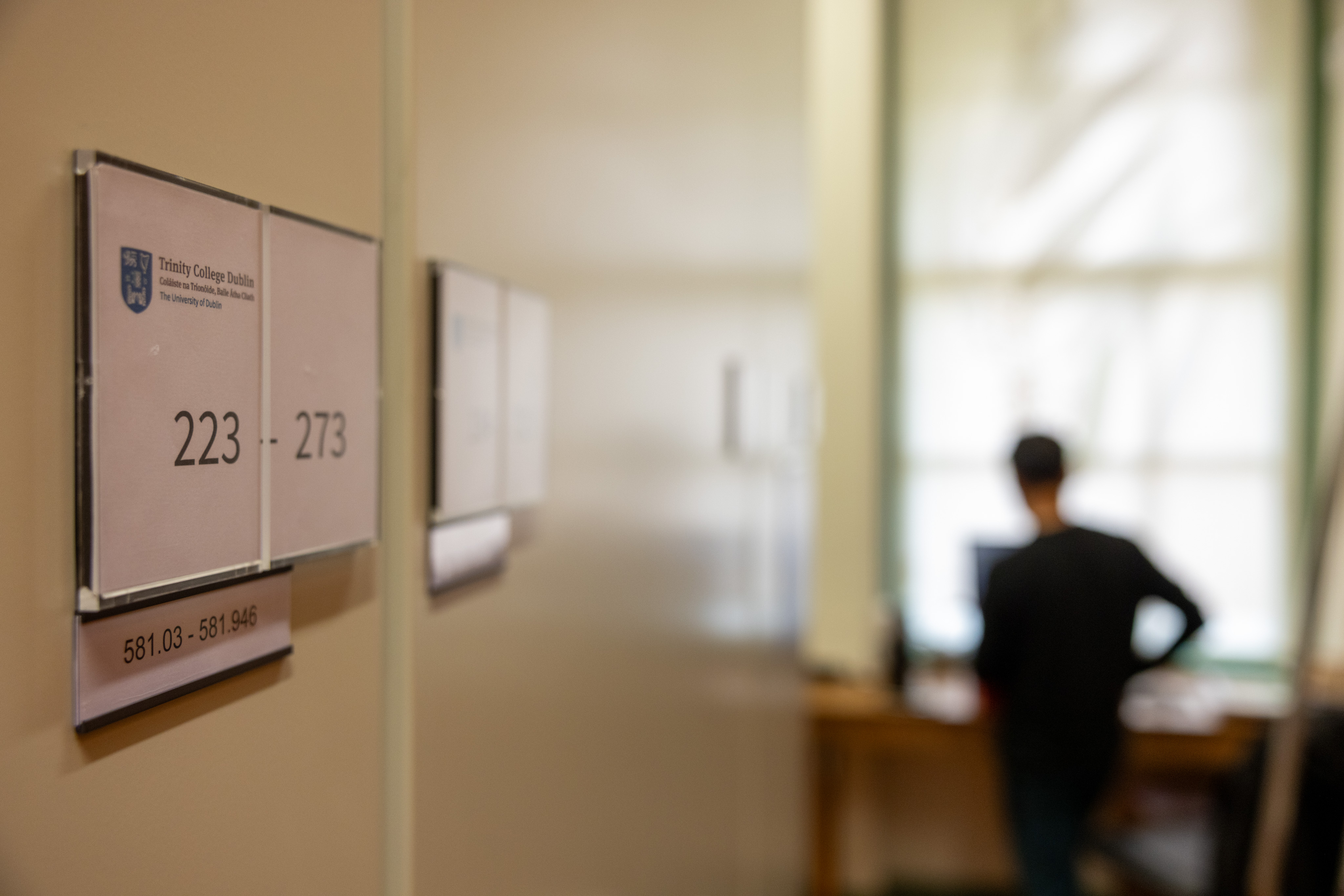 Door to digitising room standing open, with a staff member visible inside it