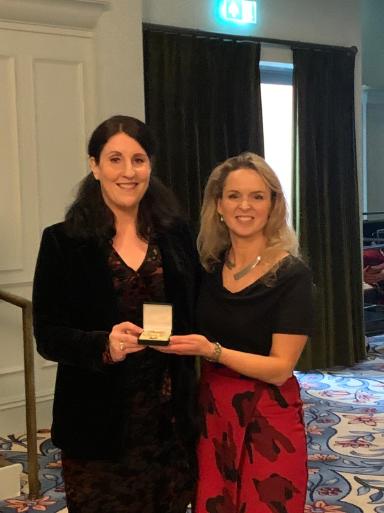 Laoise McNamara (left) being presented with her award by Tríona Lally (right)