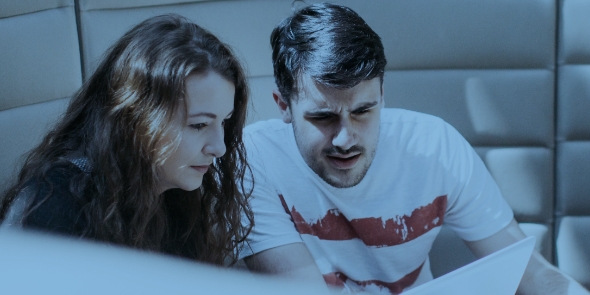 Two students looking at a paper