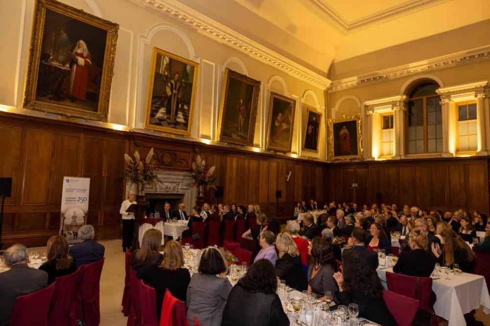 Guests seated in the Dining Hall of Trinity College Dublin listening to the President of Ireland Catherine Connolly.