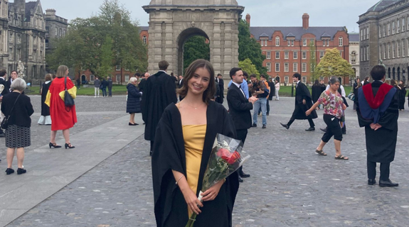A Trinity student in Scholar's robes on Front Square.