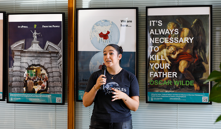 Sophie McGurk presenting in front of posters