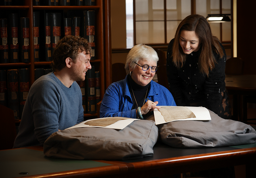 Dr Daniel Patterson, Professor Jane Ohlmeyer, and Dr Bronagh McShane from the VOICES project pictured in the National Archives of Ireland viewing records from the Court of Chancery .
