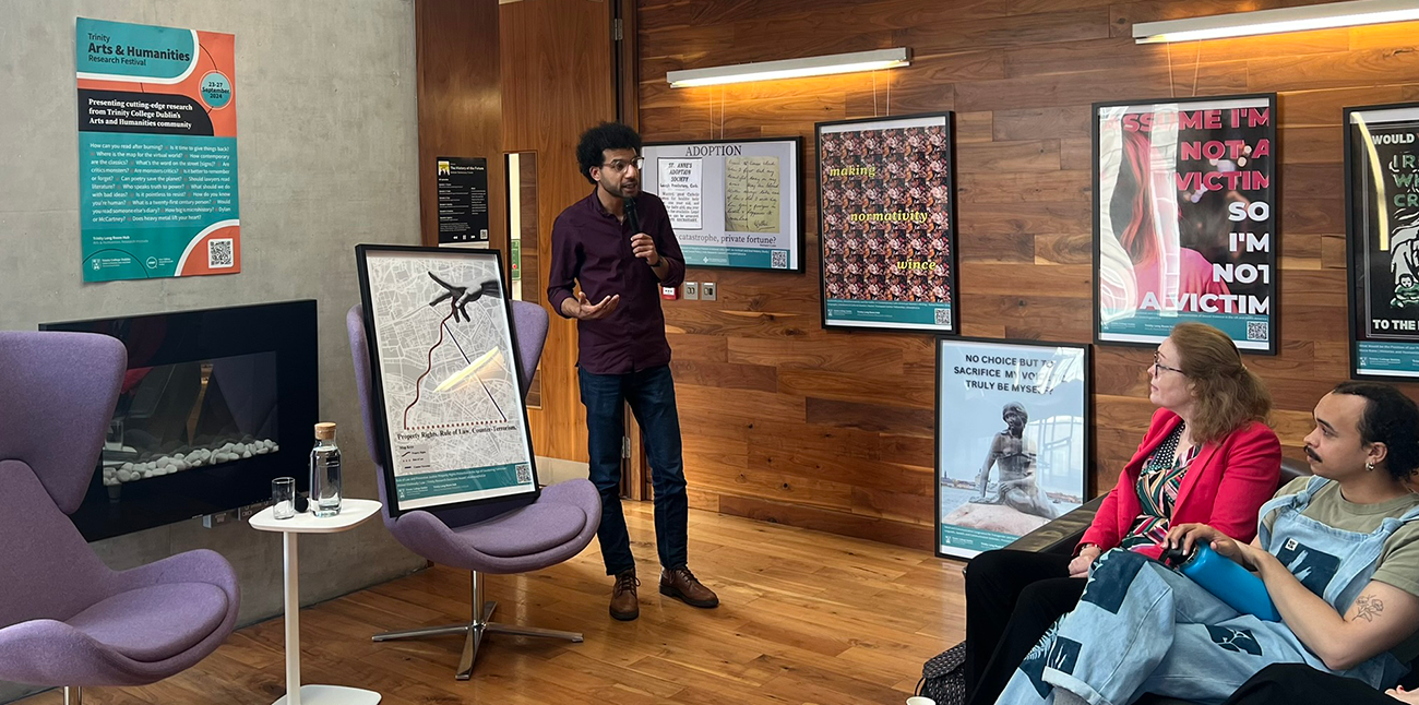 A student presenting their research poster