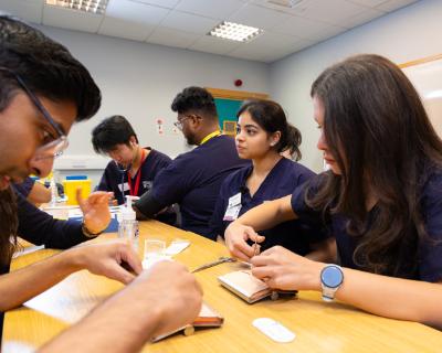 students practicing clinical skills on each other