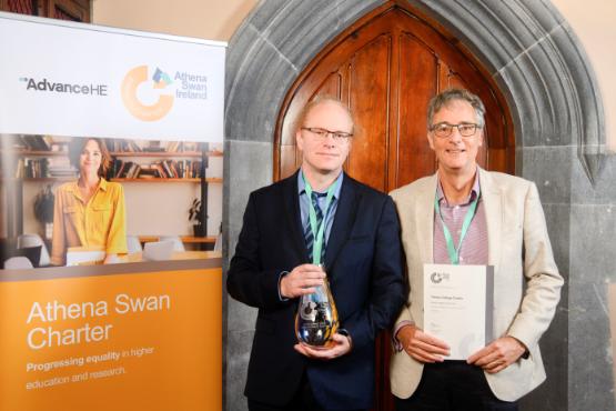 Two school representatives pose with awards
