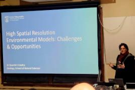 Q. Crowley presents slide to the room