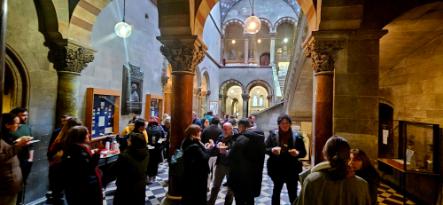 Group of people gathered for reception in museum foyer following the launch
