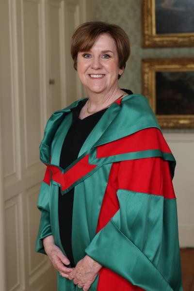A woman in degree graduation robes
