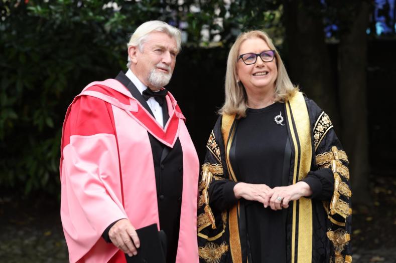 A man and woman in academic robes