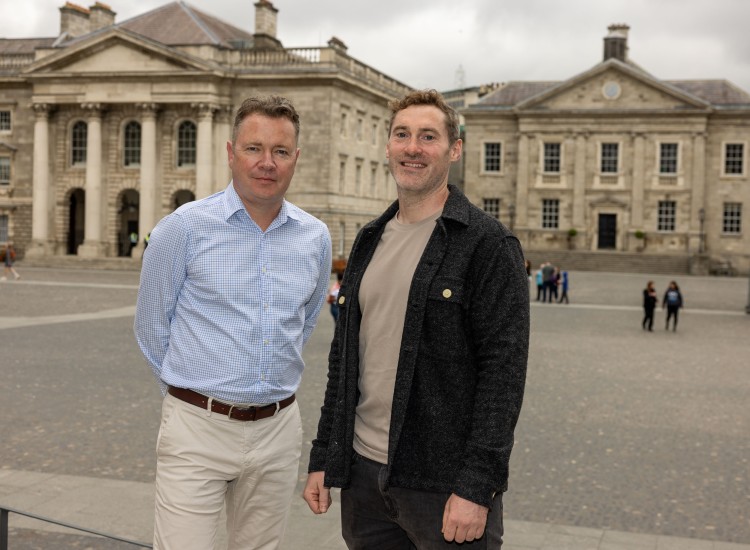 Two men photographed in an historic square