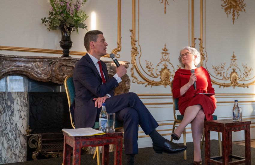 Man and woman seated in formal setting