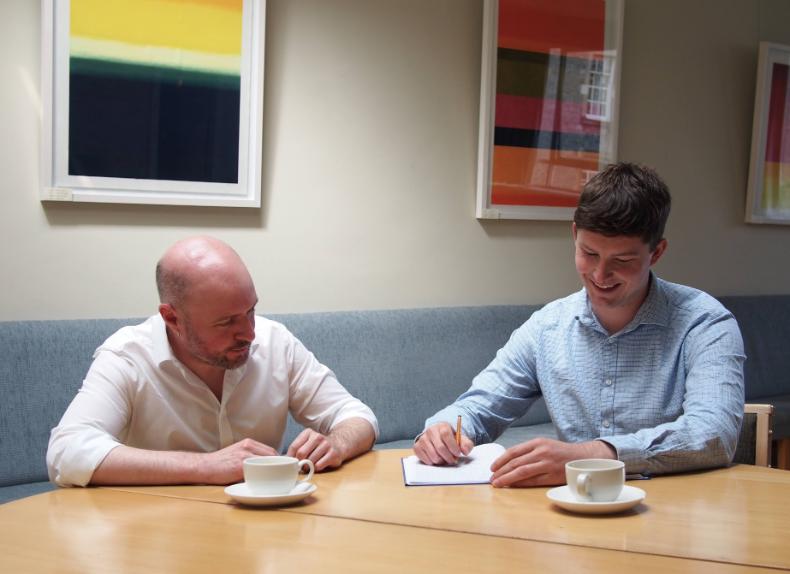 Trinity PhD candidate Andrew Burgess (right) and his research mentor Dr David O’Regan (left) work on an application of their theory.