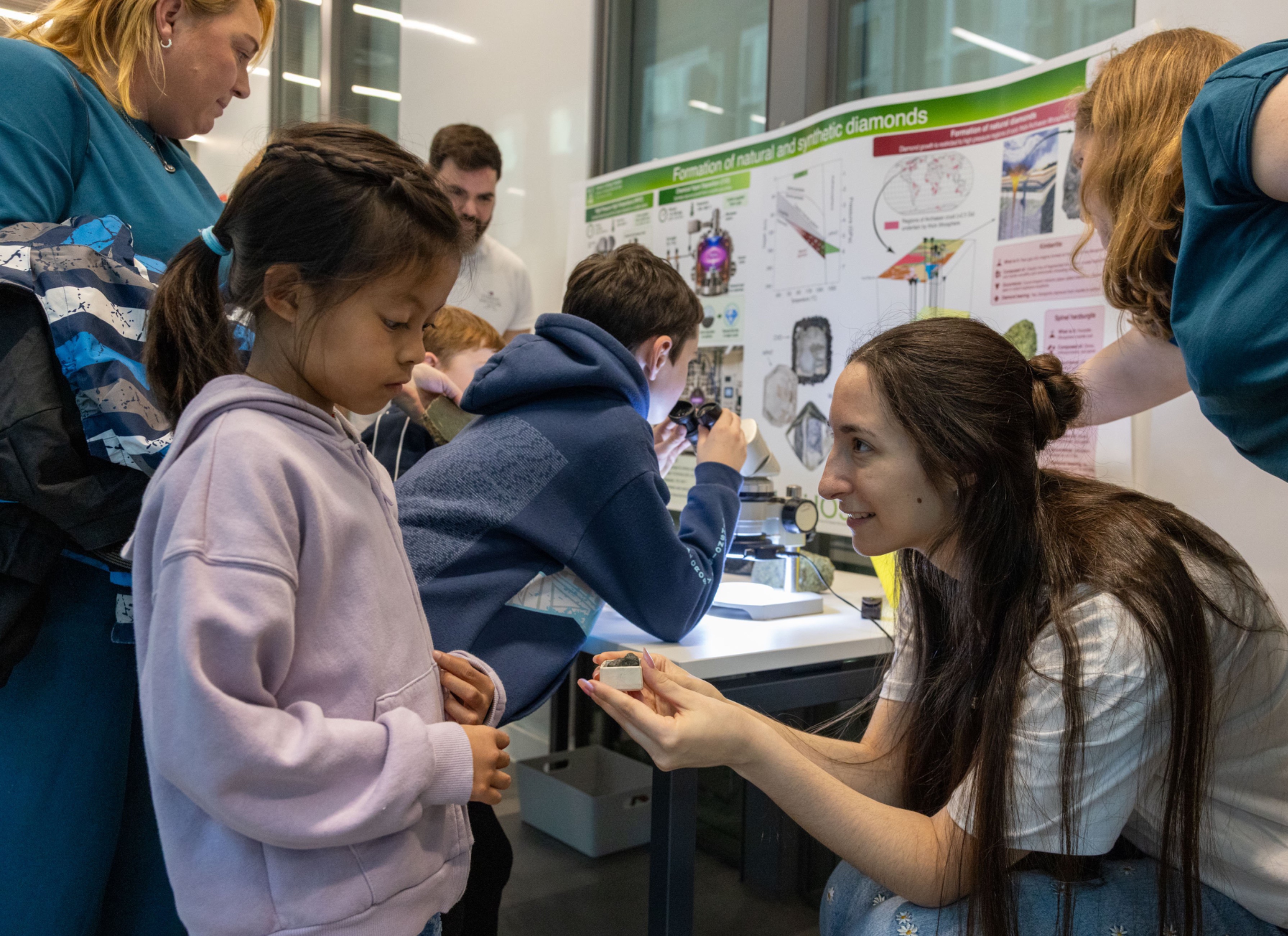 Dr Daniela Vitareli from the Litho3 ERC project chats to a child at the MIA event
