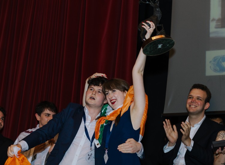 Students celebrate with trophy
