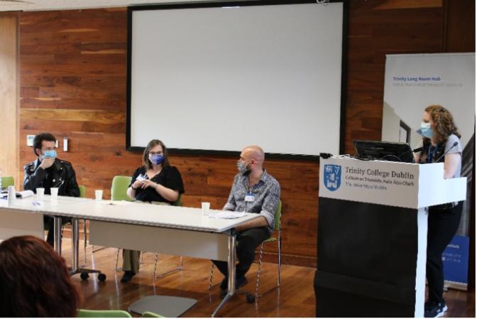 Researchers sit on a panel discussion at the conference