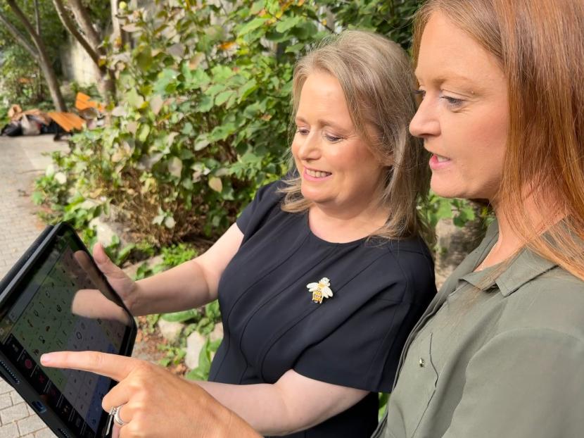 Picture of two women holding a tablet